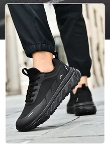 Dynamic low-angle view of black breathable mesh running shoes with thick non-slip soles