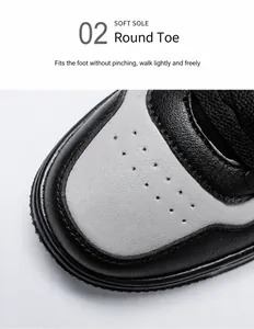 Close-up of a rounded toe with breathable perforations on a black and grey leather sneaker