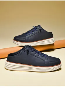 Side view of navy blue faux leather men's mule sneakers with thick white rubber soles