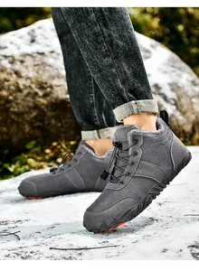 Macro view of grey outdoor snow boots with thick faux fur lining and non-slip rubber soles