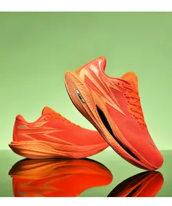Macro shot of breathable bright orange mesh upper and thick cushioned foam sole on running shoes