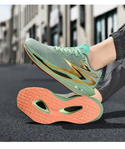 Detail of mint green mesh running shoes with orange anti-slip rubber outsole and cushioning