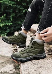 Macro detail of men's hiking boots with anti-slip rubber soles and mesh fabric