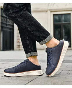 Detail of navy blue slip-on sneakers with thick white sole on a walking model outdoors