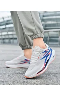 Close-up of breathable mesh running shoes with blue and red lightning patterns on the street