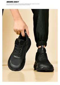 Detail view of breathable black mesh running shoes with leather patchwork and thick soles