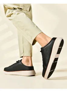 Detailed view of men's black leather mule shoes with thick white anti-slip rubber soles