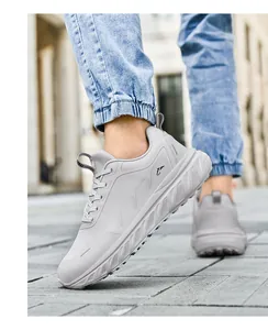 Detail of grey wide-toe running shoes with breathable mesh and thick cushioned soles