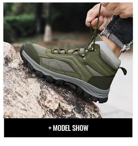 Outdoor winter hiking boots with high-top lace-up design on rocky forest terrain
