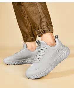 Macro detail of men's wide-toe gray running shoes with thick cushioned soles and lacing