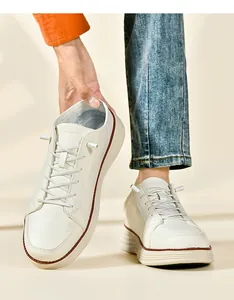 Close-up of men's cream loafers showing elastic laces and thick sole with brown trim