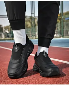 Detail of black faux leather slip-on winter shoes with structural toe stitching