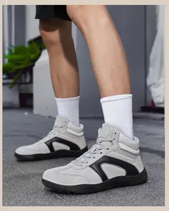 Detail of high-top casual sneakers in grey suede with black leather trim on model