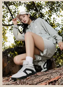 High-top grey suede outdoor sneakers shown in a scenic forest hiking environment
