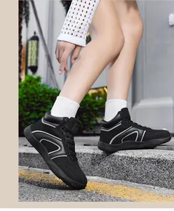 Side view of black high-top sneakers with reflective details and thick rubber soles