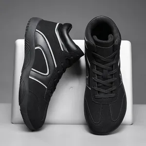 Black high-top sneakers with white accents and suede leather texture for hiking