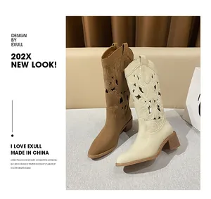 Detailed view of western boots with hollow embroidery patterns and vintage block heels