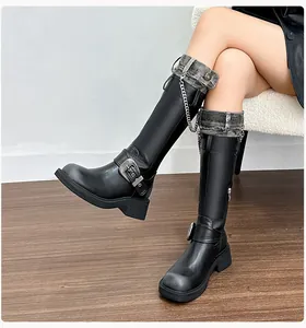 Detail of knee-high boots with distressed denim trim and decorative metal chain