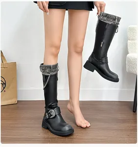 Detail of platform knight boots featuring denim cuff拼接, metal chains and chunky soles