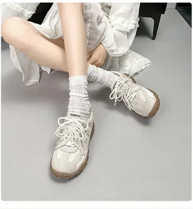 Detailansicht beige Retro-Sneaker mit Perlenschnürsenkeln und weißen Socken