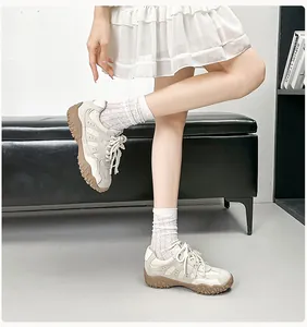 Detail von Ballet-Leder-Sneakern mit Perlenschnürsenkeln und dicken Sohlen am Modell