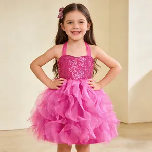 Detail of girls fuchsia sequin party dress with ruffled mesh layers and matching hairpin