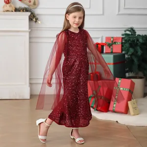 Detail of burgundy sequin girls' dress with mesh cape sleeves and fish-tail hem silhouette