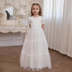 Close-up of elegant white girls lace princess dress with multilayered tulle and lace trim
