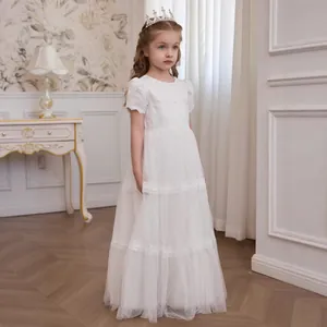 Close-up of white girls princess dress featuring short sleeves and layered lace mesh
