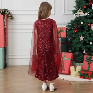 Detail of red sequined girl's dress with translucent mesh cape for Christmas performance