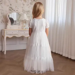 Detailed back view of white lace flower girl dress with layered tulle and puff sleeves