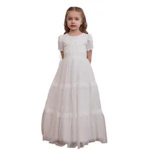 Detail of white flower girl dress with layered tulle skirt and delicate lace hem