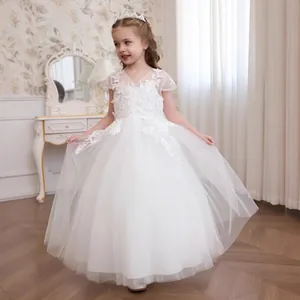 Close-up of intricate lace flower embroidery and mesh layers on girls princess dress