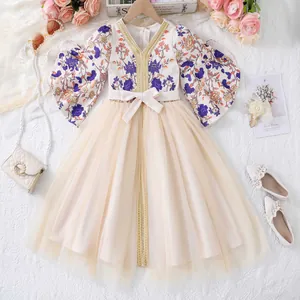 Detail of floral embroidery and gold trim on the neck of this girl princess dress