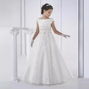 Close-up of intricate white embroidery and delicate bow on flower girl dress bodice
