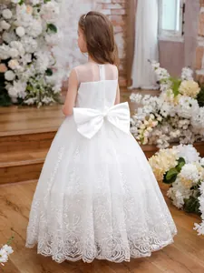 White flower girl dress featuring back lace embroidery and a large satin bow on the waist