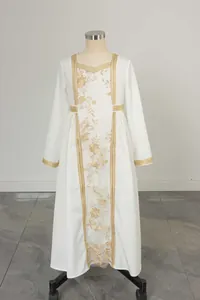 Close-up of golden floral embroidery and lace details on a white elegant long dress