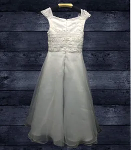 Detail of white flower girl dress featuring intricate lace petals and tiered tulle skirt