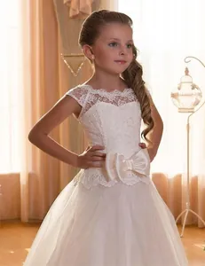 Detailed view of white floral lace bodice and satin bow on girls princess tulle dress