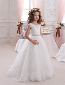 Dettaglio del ricamo in pizzo bianco su un abito da principessa senza maniche per bambine