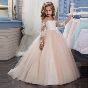 Detail of elegant champagne tulle flower girl dress with intricate white lace embroidery