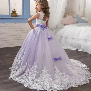 Detail of the purple lace flower girl dress with a large silk bow and cascading mesh train