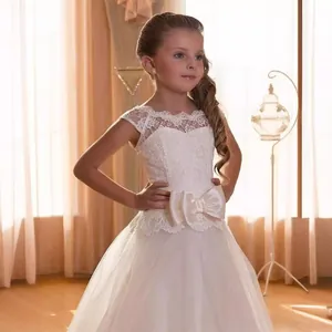 Elegant white lace flower girl dress with large waist bow and layered tulle tutu skirt
