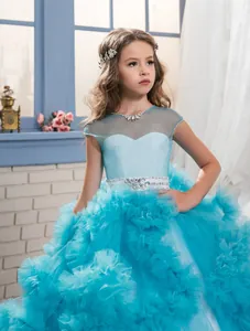 Macro shot of sky blue kids ball gown detailing layered mesh and rhinestone accents