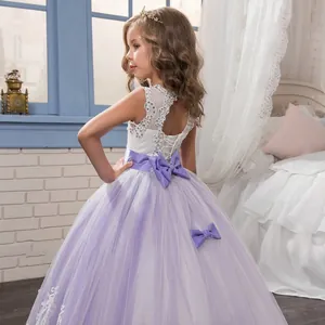 Detailed back view of lace princess dress featuring a large satin bow and lavender tulle