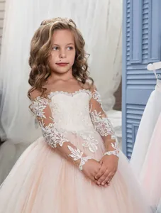 Champagne pink flower girl dress with long lace sleeves and layered tulle floor length skirt