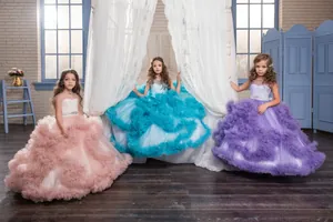 Detailed view of layered tulle skirts in pink, blue, and purple for girls' gowns