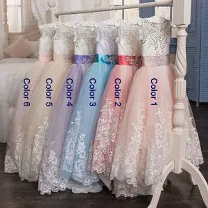 Detail of flower girl dresses showing silver sequins, floral lace, and multi-color sashes