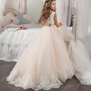 Sleeveless champagne lace flower girl dress with layered tulle skirt and satin bow accent