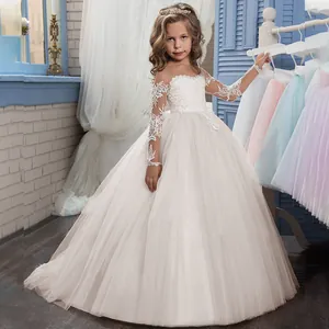 Close-up of white girls ball gown with long sleeves and elegant floral lace embroidery